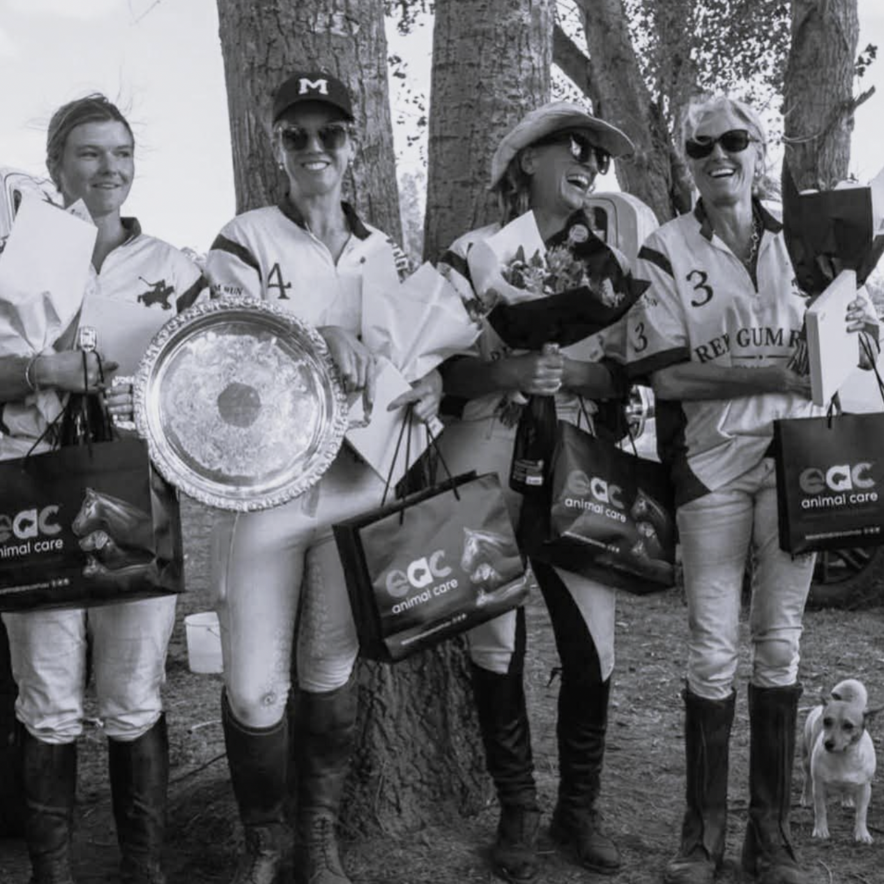 Women polo players celebrating with a trophy